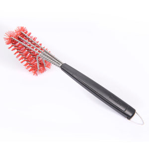 Red wire brush with black handle for cleaning BBQ grates.