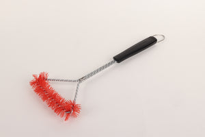 Red grill brush with black handle and metal chain.