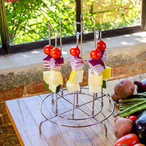Metal stand holding skewers with cheese, onion, and tomato.