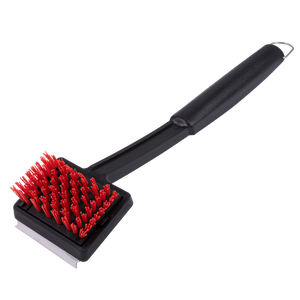Black grill brush with red bristles and long handle.