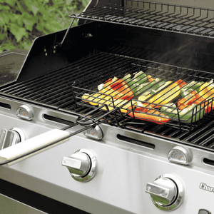 Silver Char-Broil gas grill with vegetable basket on cooking grate.